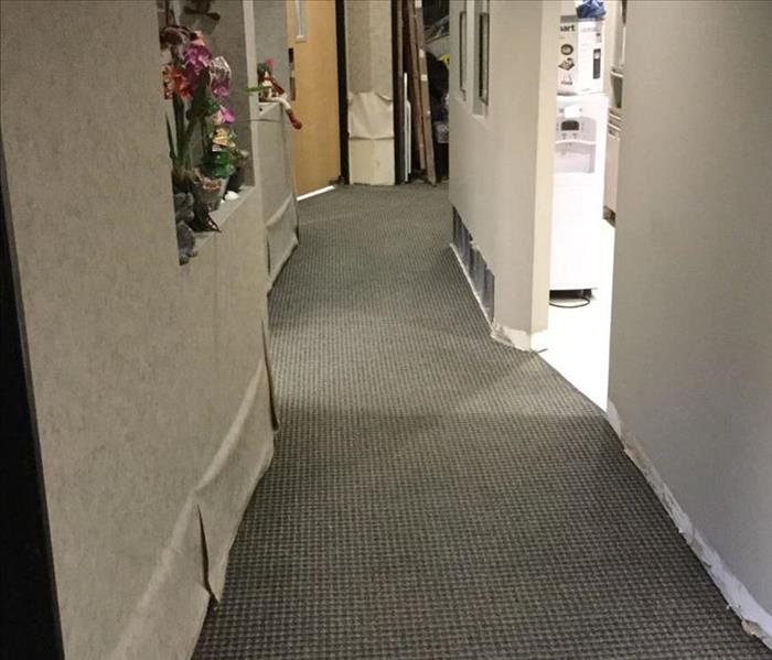 Dental office hallway with wallpaper pulled back down and equipment removed