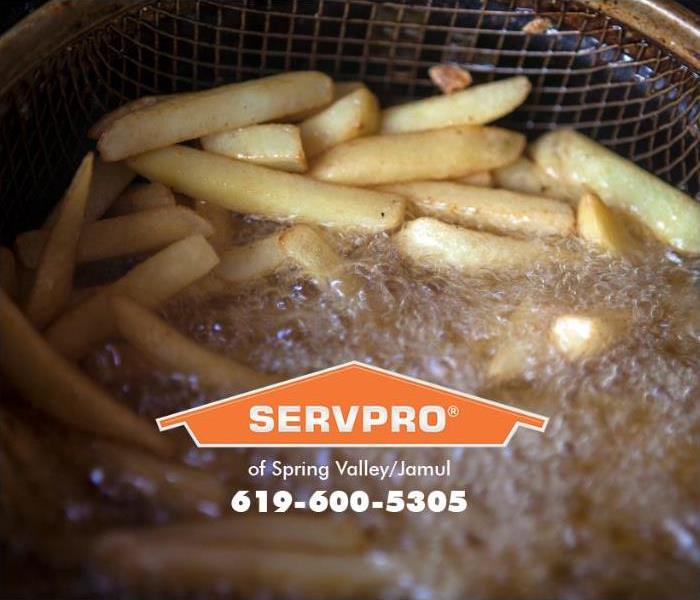 A deep fryer is shown frying French fries.