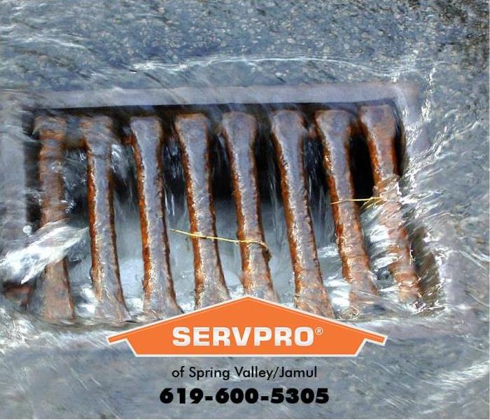 Water is shown rushing into a storm drain.