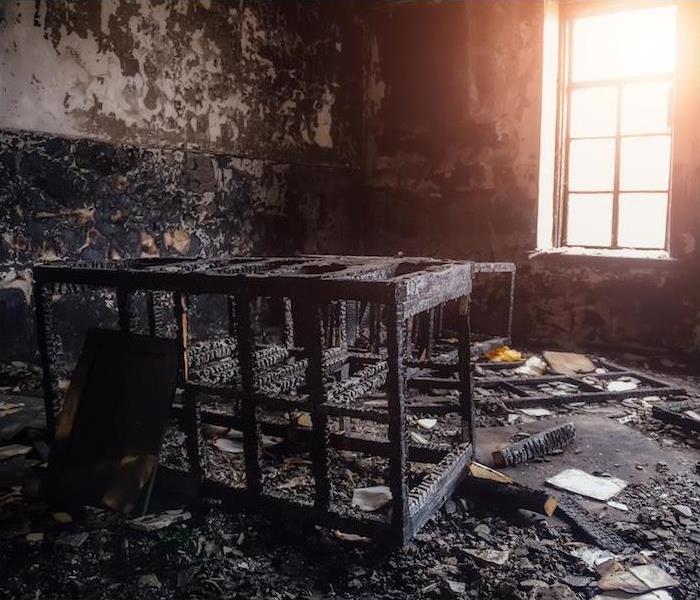 Image of a room with burnt walls and wood furniture